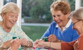 Senior women playing cards